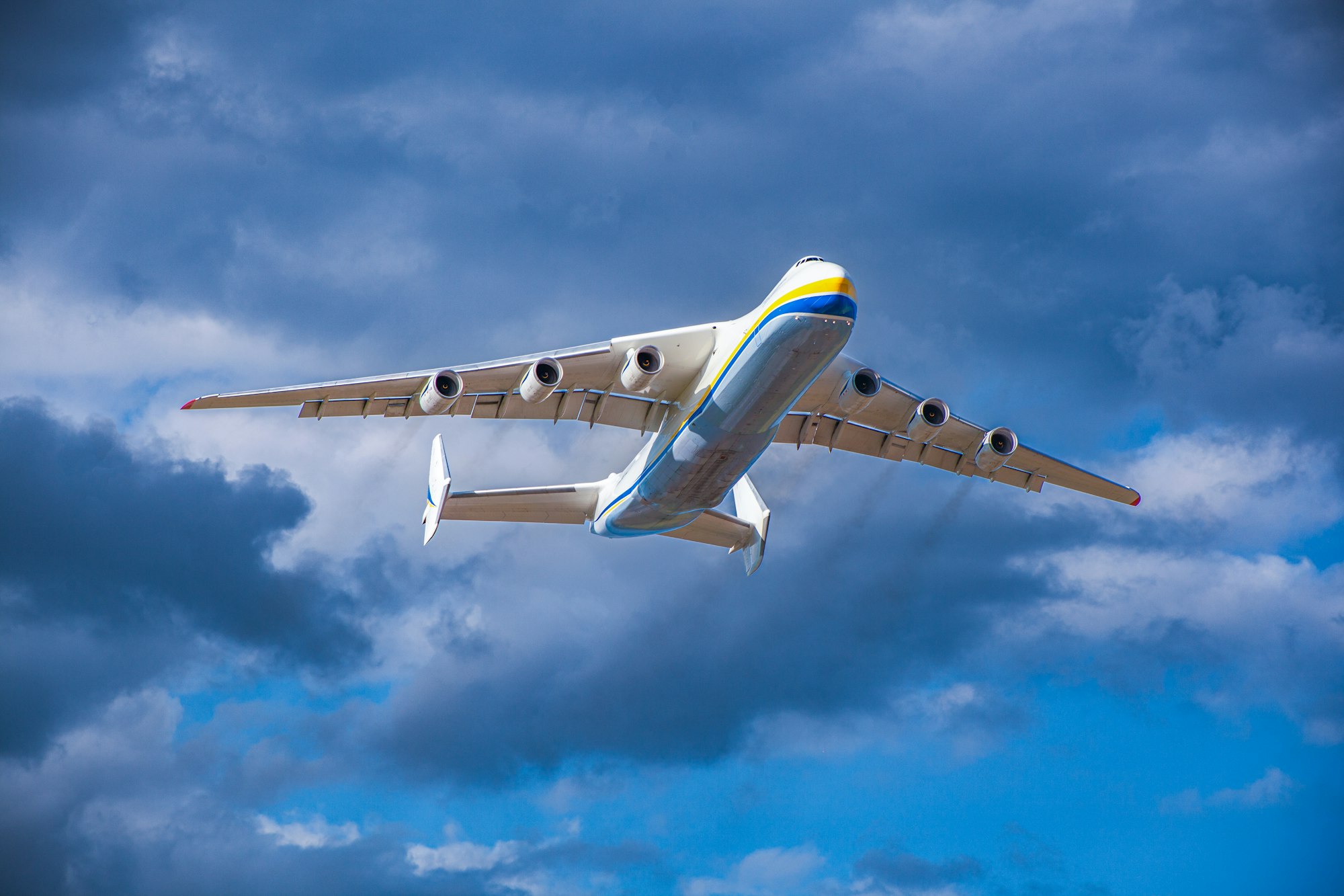 A large cargo plane flies in the blue sky. Aviation air transport. Airplane symbol.